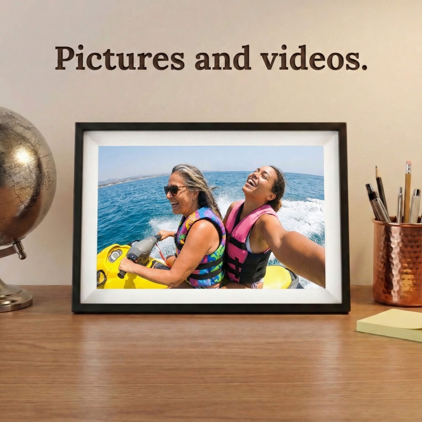 A 10-inch cordless classic black Family Frame digital memory display with an elegant white mat sitting comfortably on a wooden desk next to a classic globe. Equipped with advanced processing, this premium cordless digital picture frame seamlessly handles both high-definition photo and video playback to capture full memories. The robust photo sharing frame allows distant relatives to securely send video messages directly to any room in the house.
