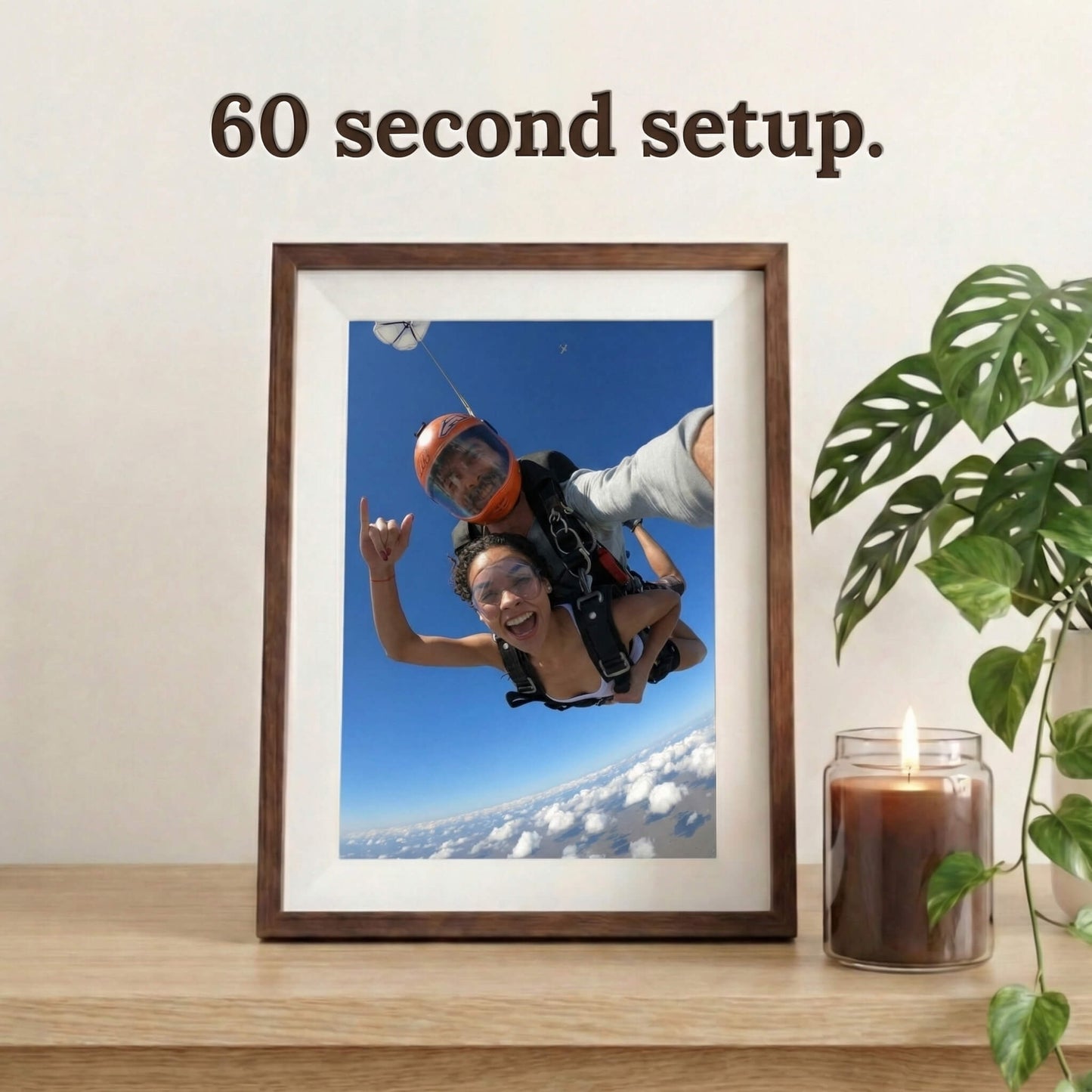 A 10-inch cordless mocha wood Family Frame electronic photo frame framed by a white mat, displayed prominently on a light wooden table next to a large indoor plant. Prioritizing accessibility, this intuitive battery-powered smart picture frame boasts a frictionless, easy 60-second WiFi setup process that anyone can master. This no subscription fee digital frame ensures immediate and uninterrupted photo sharing for families of all technical backgrounds.
