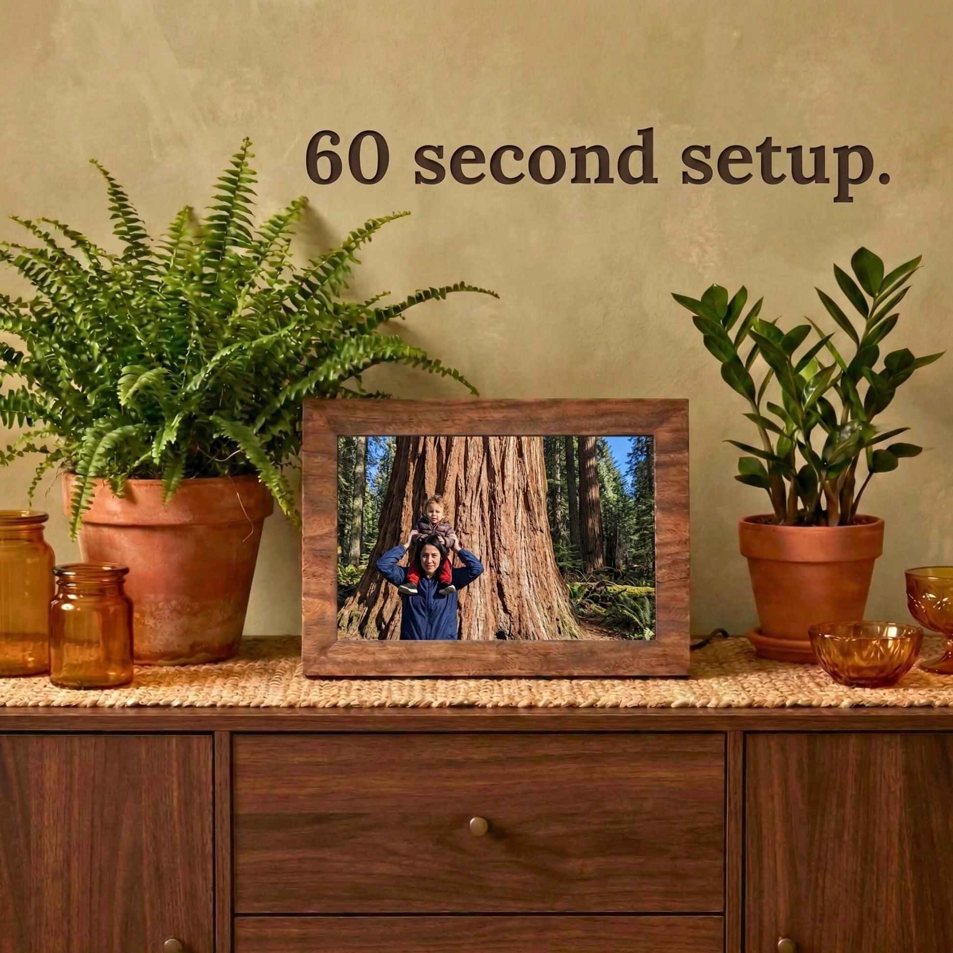 A 10-inch oak wood Family Frame electronic photo frame displayed prominently on a rich wooden credenza alongside rustic decor. Prioritizing accessibility, this intuitive smart picture frame boasts a frictionless, easy 60-second WiFi setup process right out of the box. This completely no subscription fee digital frame ensures immediate and uninterrupted photo sharing for families of all technical backgrounds.
