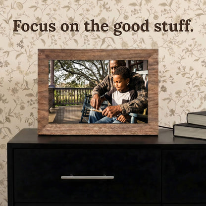 A 10-inch oak wood Family Frame smart picture frame situated on a dark modern dresser against patterned wallpaper. Engineered for vivid visual storytelling, this WiFi photo frame delivers a stunning high-resolution display that beautifully highlights the intricate details of every uploaded image. Acting as an impressive digital memory display, it bridges the physical distance between family members with a constant stream of new photos.
