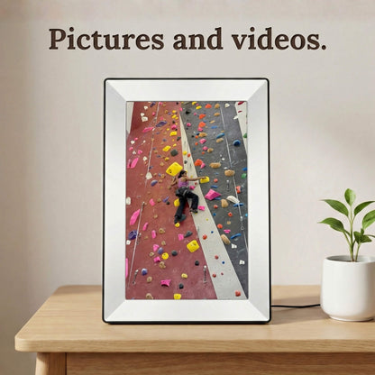 A 10-inch white Family Frame digital memory display standing vertically on a minimalist bedside table. Engineered for dynamic storytelling, this advanced digital picture frame supports flawless high-definition photo and video playback. Ideal for keeping extended relatives connected, the photo sharing frame allows unlimited users to upload vibrant video memories directly via a secure wireless connection.
