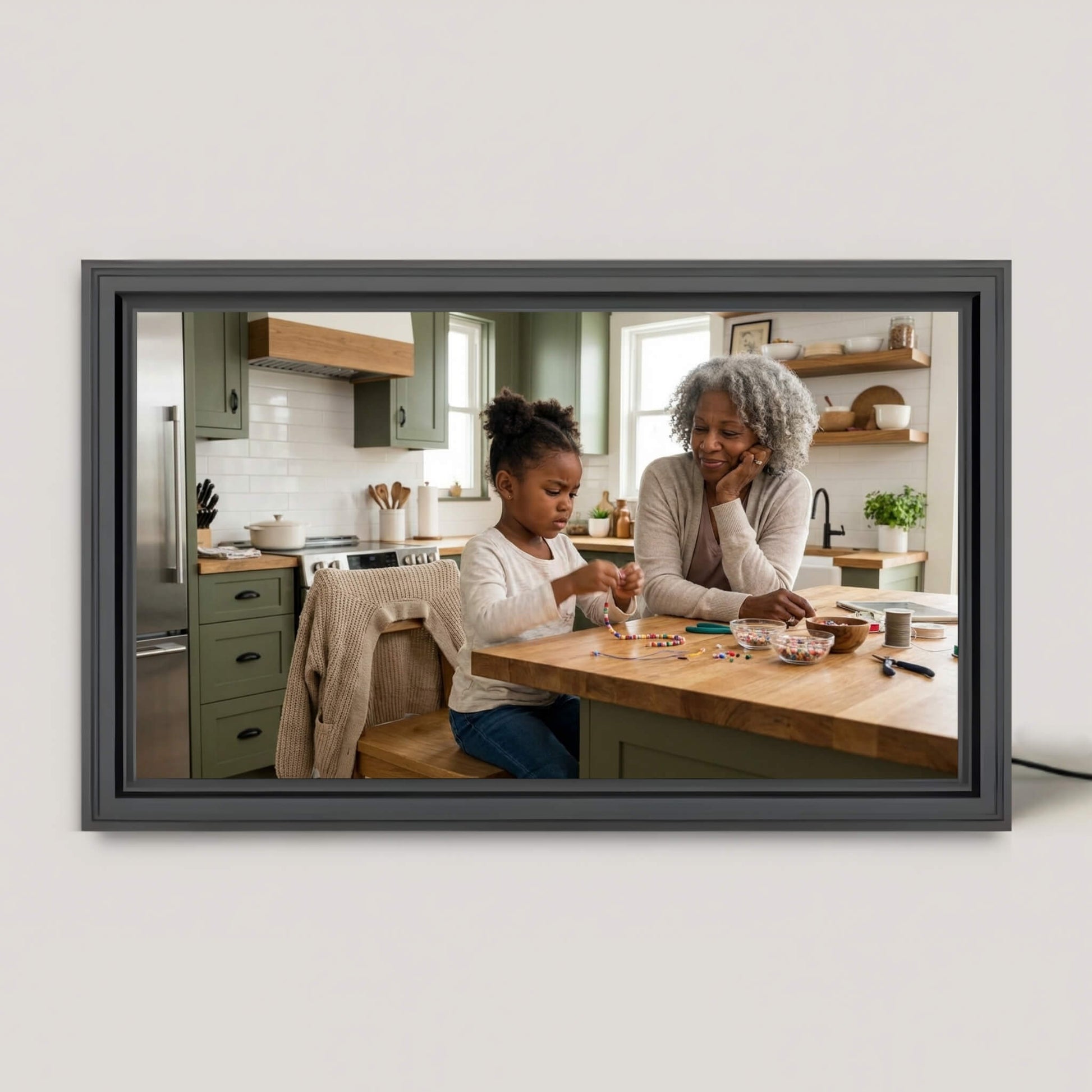 A 16-inch studio black Family Frame digital picture frame resting on a bright kitchen island, displaying a crisp family photo. This premium smart picture frame features an HD digital photo display designed to seamlessly blend into home decor while sharing everyday moments. Built as the ultimate long-distance family gift, this WiFi photo frame keeps loved ones connected with zero subscription fees.
