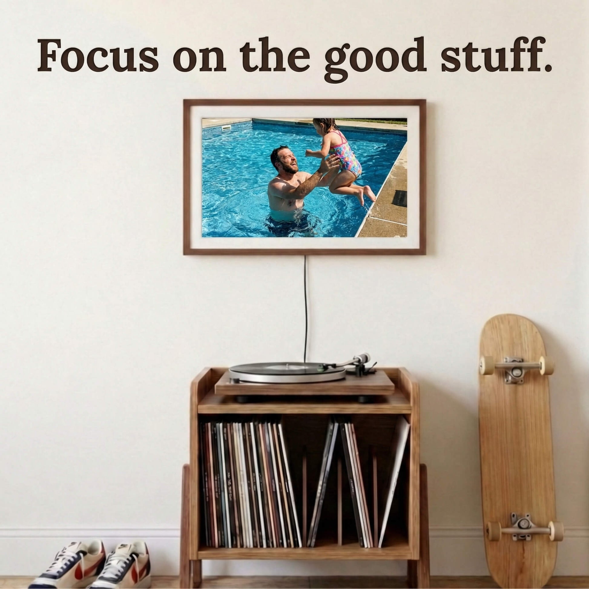 A 20-inch oak wood Family Frame smart picture frame framed by a white mat, mounted above a mid-century modern record console. Engineered for vivid visual storytelling, this large WiFi photo frame delivers a stunning high-resolution display that beautifully highlights the intricate details of every uploaded image. Acting as an impressive digital memory display, it bridges the physical distance between family members with a constant stream of new photos.
