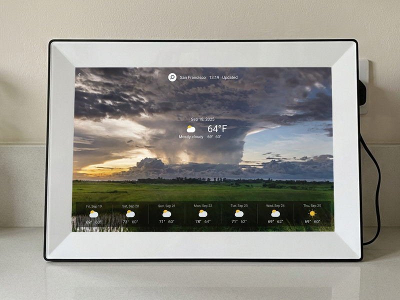 Beautiful live weather display feature on a digital frame for grandparents, showing the current temperature and a multi-day forecast elegantly overlaid on a scenic background picture.
